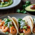 spicy shrimp tacos with avocado salsa sour cream cilantro sauce